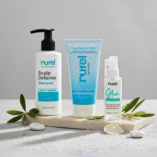 Nurel hair care products including shampoo, mask, and serum on a gray background with green leaves.